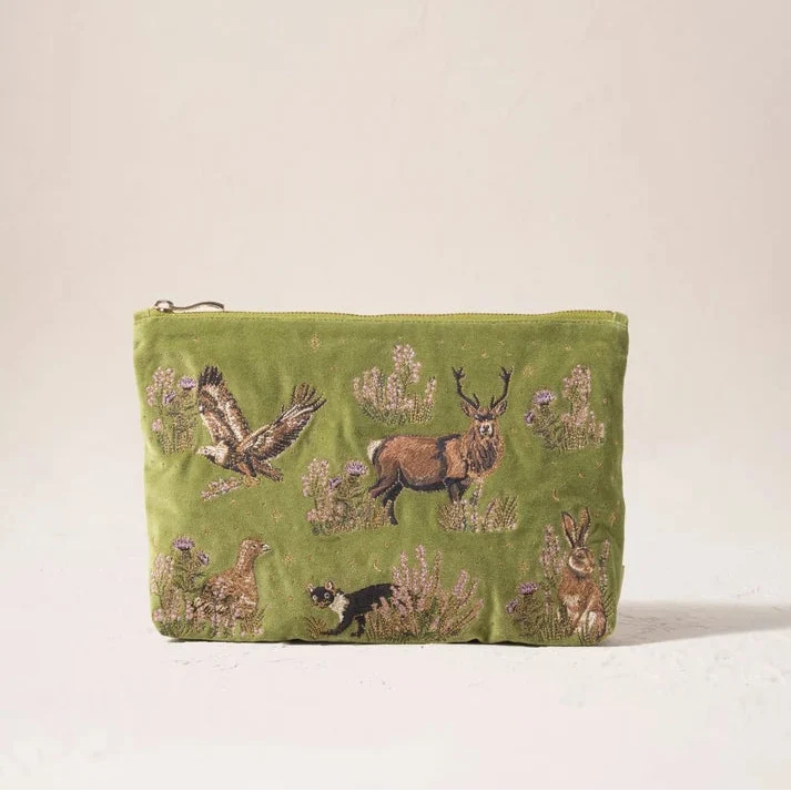 An olive green velvet pouch featuring embroidered woodland animals including a deer, owl, rabbit, and bird, set against a plain off-white background.