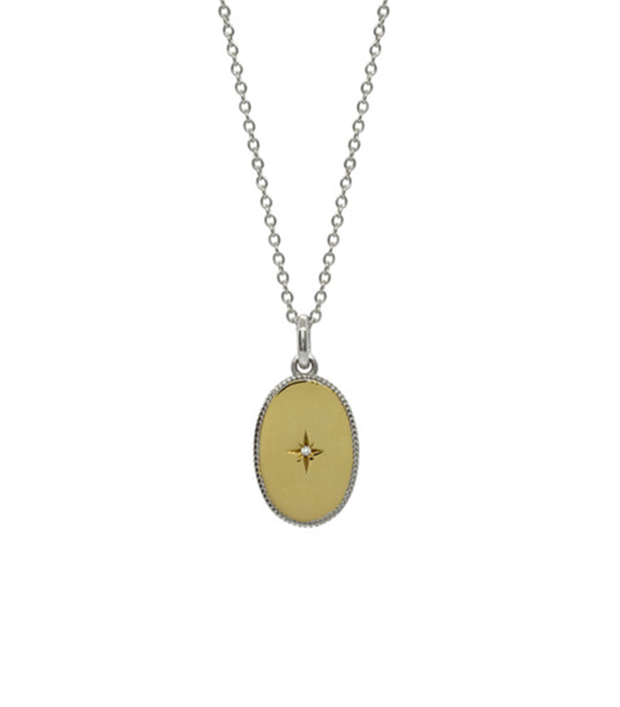 A gold vermeil necklace. The necklace has a dainty sterling silver chain with a gold vermeil oval pendant.