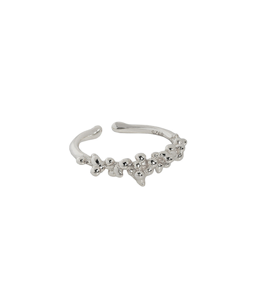 A sterling silver ring. The ring has an open band design with a bubble texture at the front.