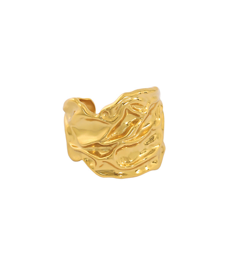 A gold vermeil ring with a thick band. The ring is textured with intricate detailing showing water ripples.