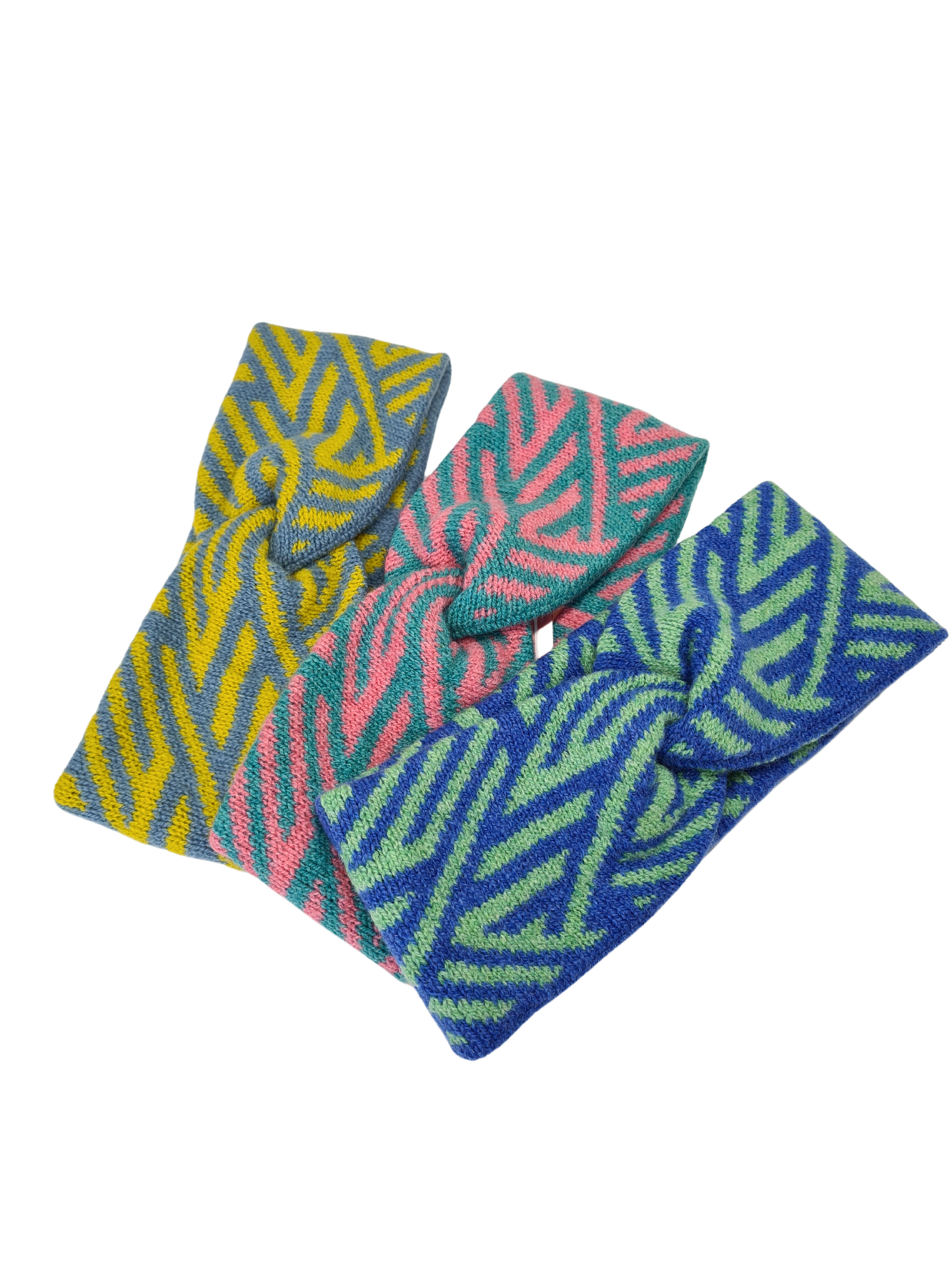 A selection of 3 twist headbands. The headbands have a crosswise pattern in yellow and blue, pink and turquoise, green and blue.
