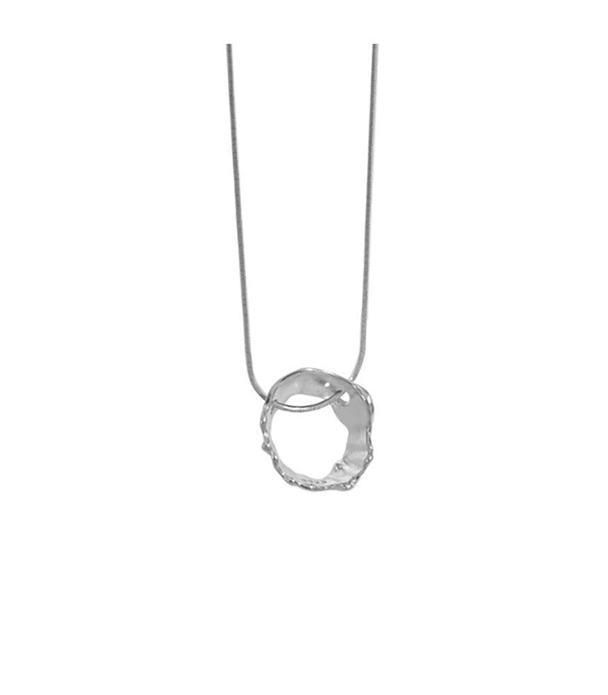 A sterling silver necklace with an irregular circle shaped pendant, resembling the movements of water.