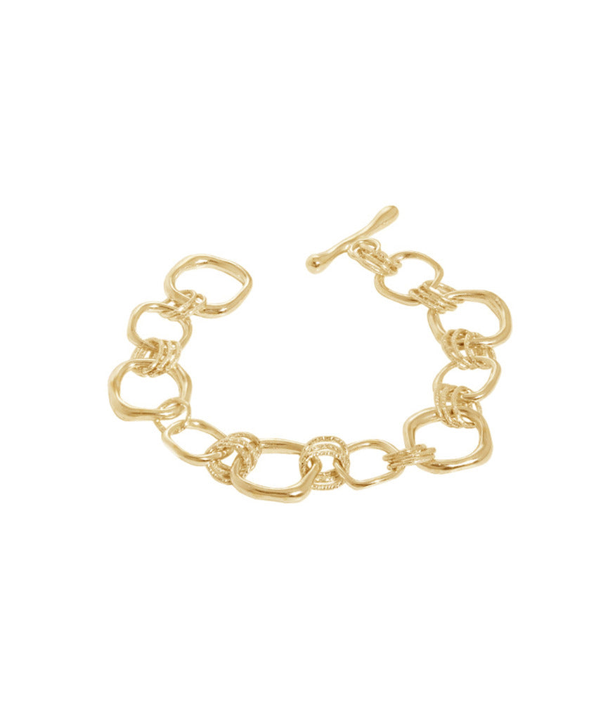 A gold vermeil link bracelet made up of multiple irregular shaped circle rings, linked together.