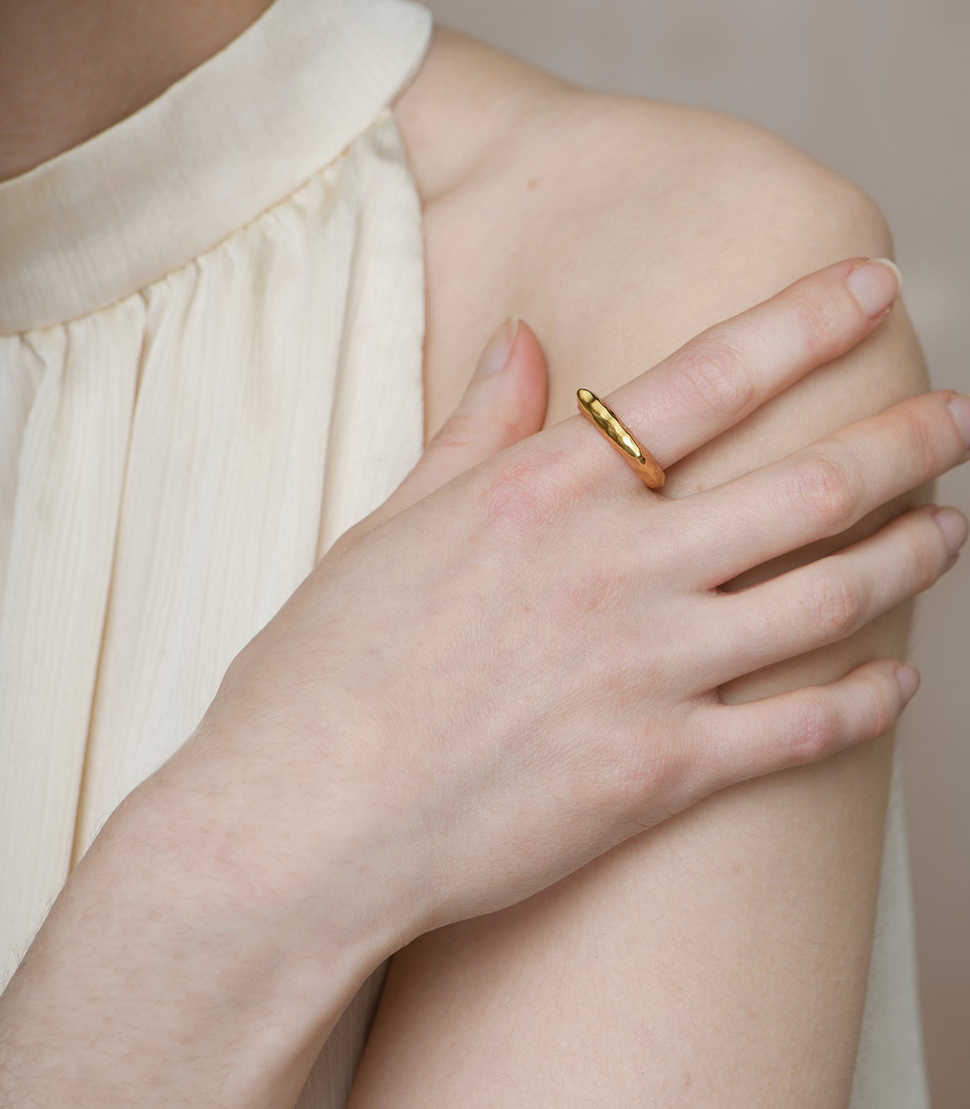 A gold vermeil, plateau open band ring on a model.
