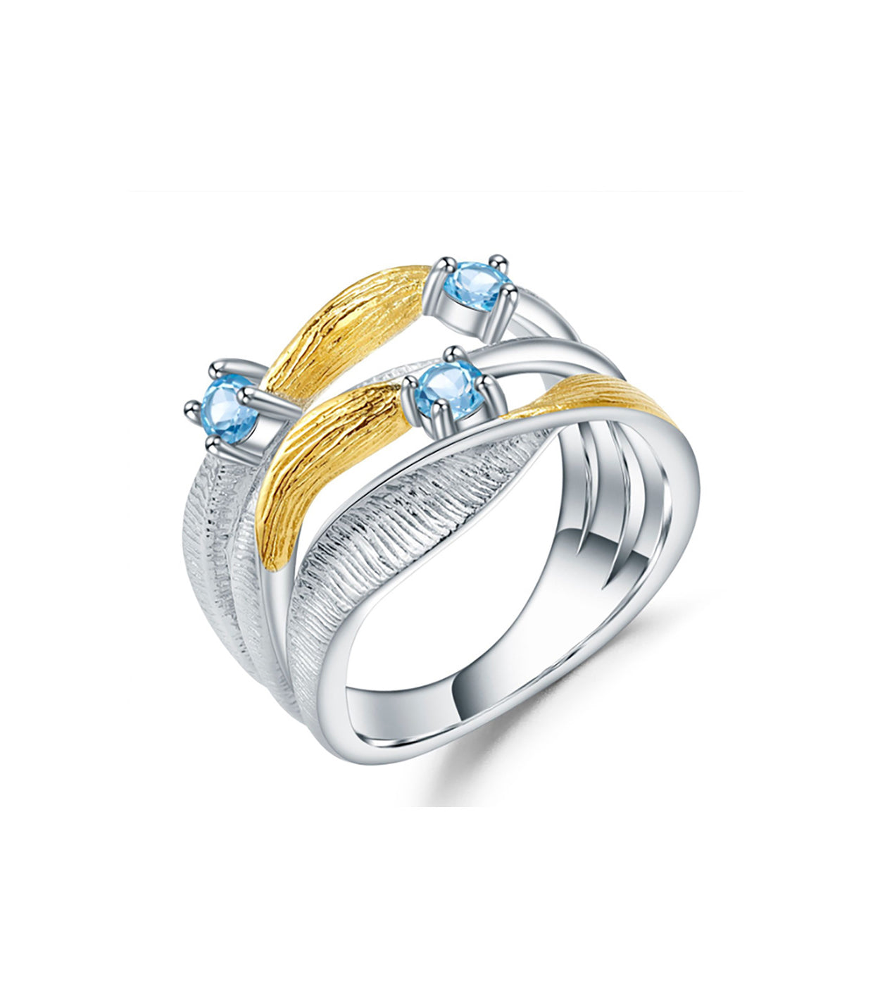 A mixed metal gold vermeil and sterling silver ring with 3 bands. The ring also features 3 Swiss topaz stones.