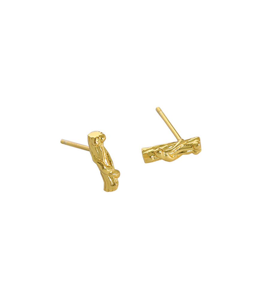 A pair of gold plated small stud earrings. The earrings are shaped and textured to resemble tree branches.