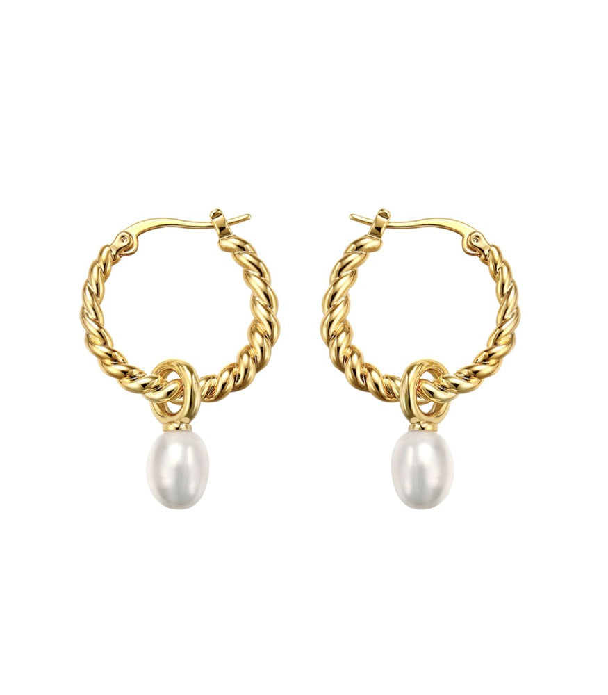 A pair of gold plated twisting hoop earrings. The twisting hoop earrings have two white pearls delicately hanging from them. 