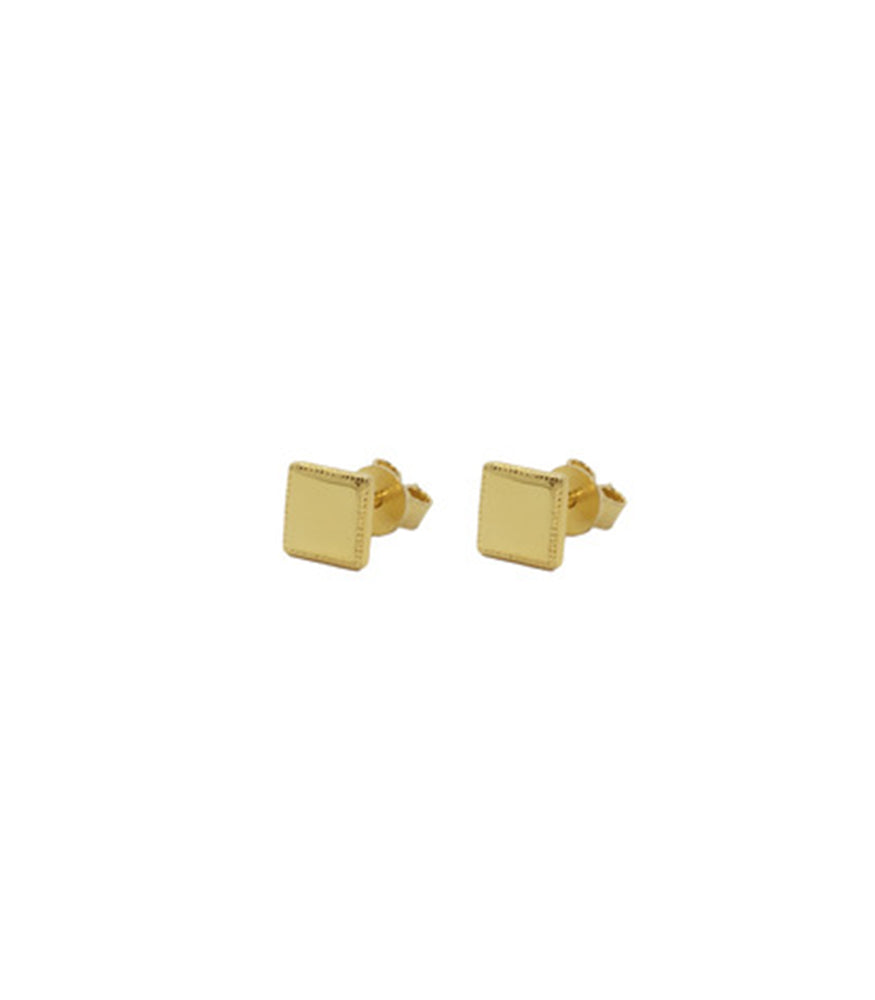 A side profile of a pair of gold plated earrings. The earrings are a pair of small square studs.