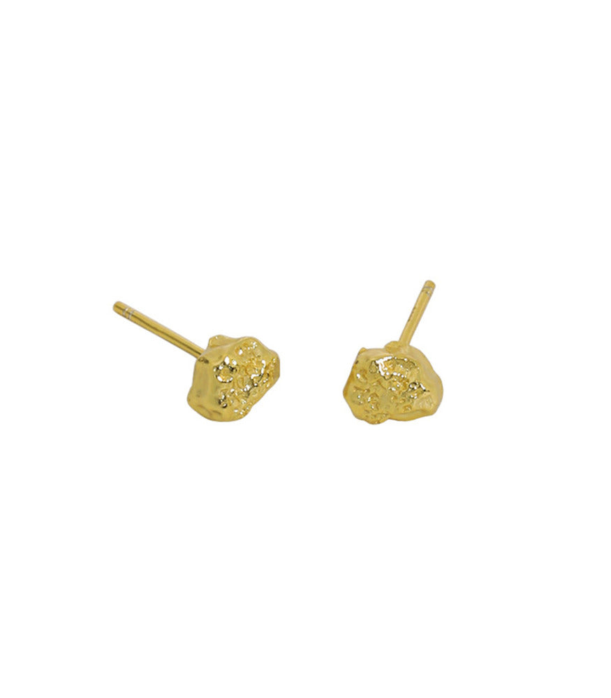 A pair of gold plated earrings. The earrings are a pair of small textured nugget studs.