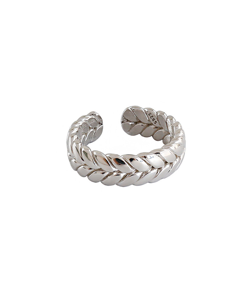 A sterling silver ring. The band of the ring is detailed to resemble a twisting braid.
