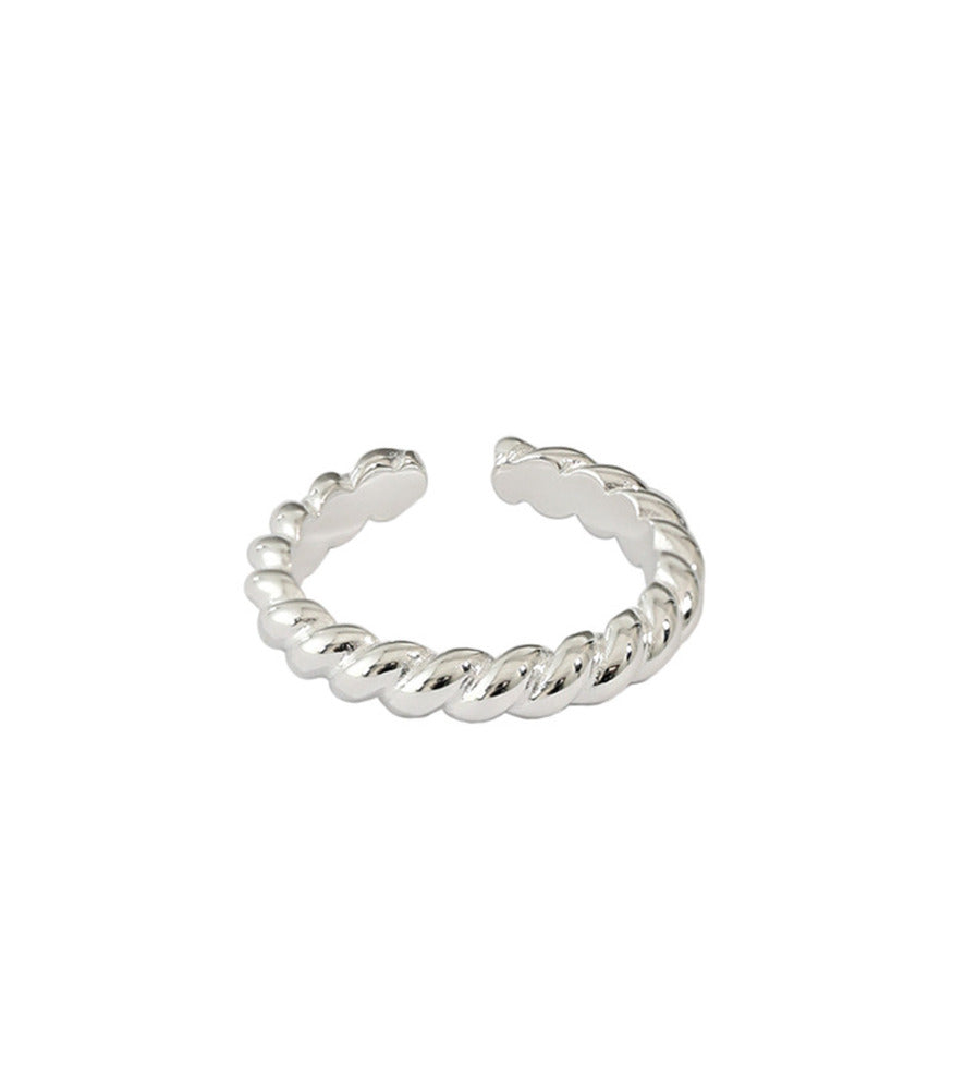 A sterling silver twisting rope detailed band. The ring has an open band design.  