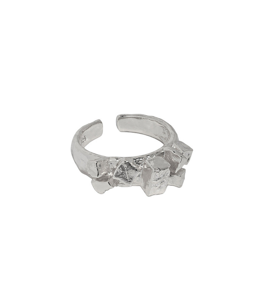 A sterling silver ring. The ring has a chunky band with textured cobbles adding visual interest to the piece.