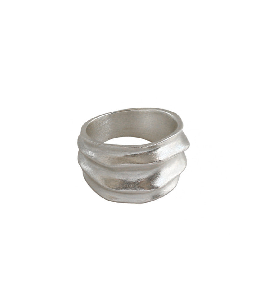 A sterling silver ring. The ring has a chunky band width with ridges and valleys.