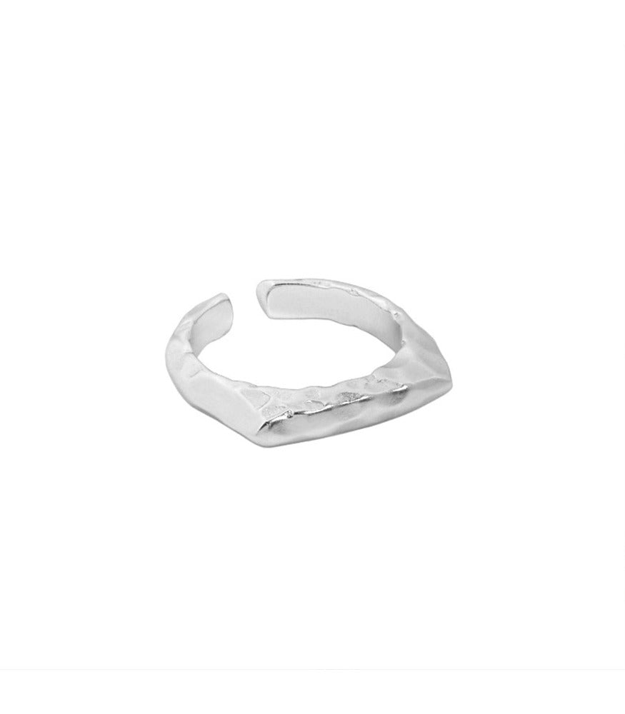 A sterling silver ring. The ring is a textured plateau open banded ring. 