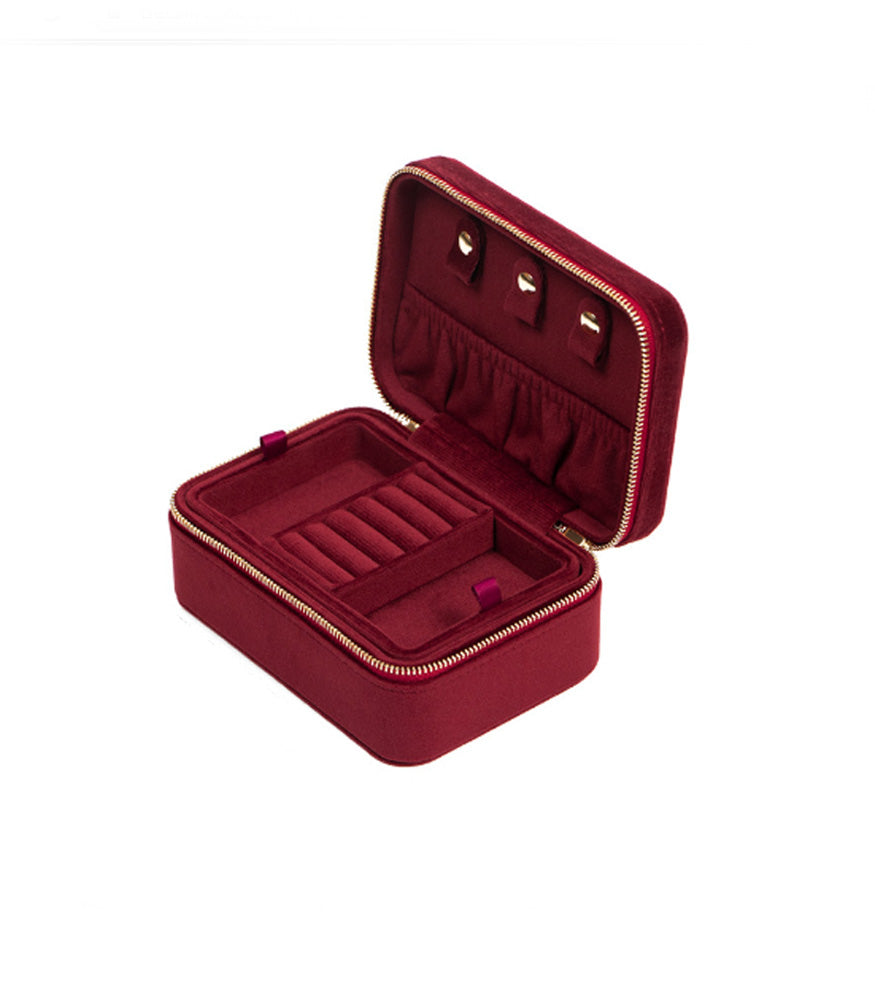 A dark red, rectangular jewellery box in a beautiful velvet fabric.