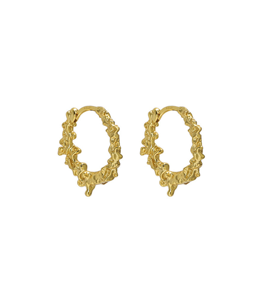 A pair of gold vermeil textured hoop earings. The earrings feature details resembling water droplets.