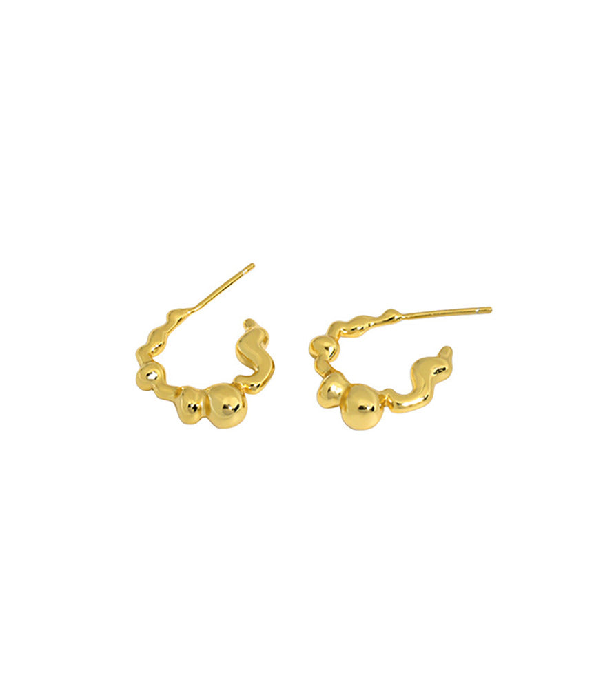 A pair of gold vermeil earrings with a bubble texture design.
