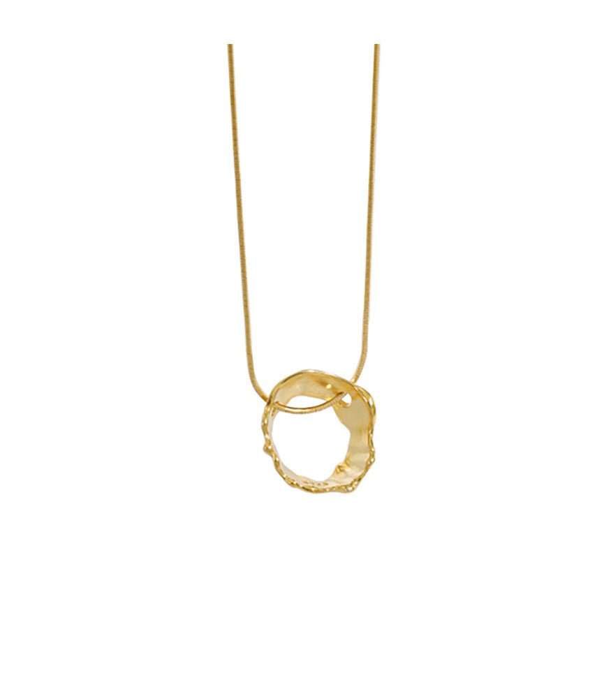 A gold vermeil necklace, the necklace has an irregular shaped circle pendant, reflective of waters movements.