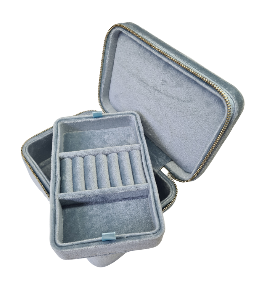A light blue, rectangular velvet jewellery storage box. The box has two layers and a zip fastening. 