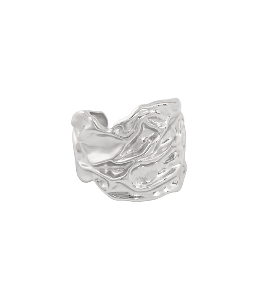 A sterling silver ring with a thick band and intricate detailing resembling the surface of a loch, with water ripples.