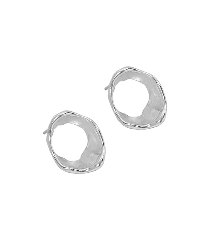 A pair of sterling silver circle stud earrings. The earrings have an organic shape which is inspired by flowing water.