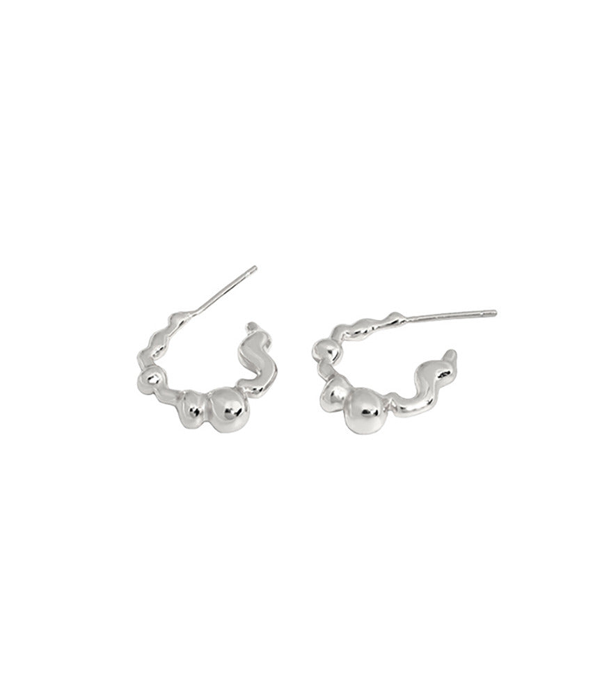 A pair of sterling silver earrings with a bubble texture design. 
