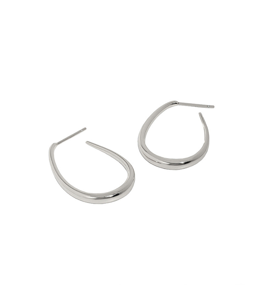 A pair of sterling silver polished oval hoop earrings in a teardrop shape.